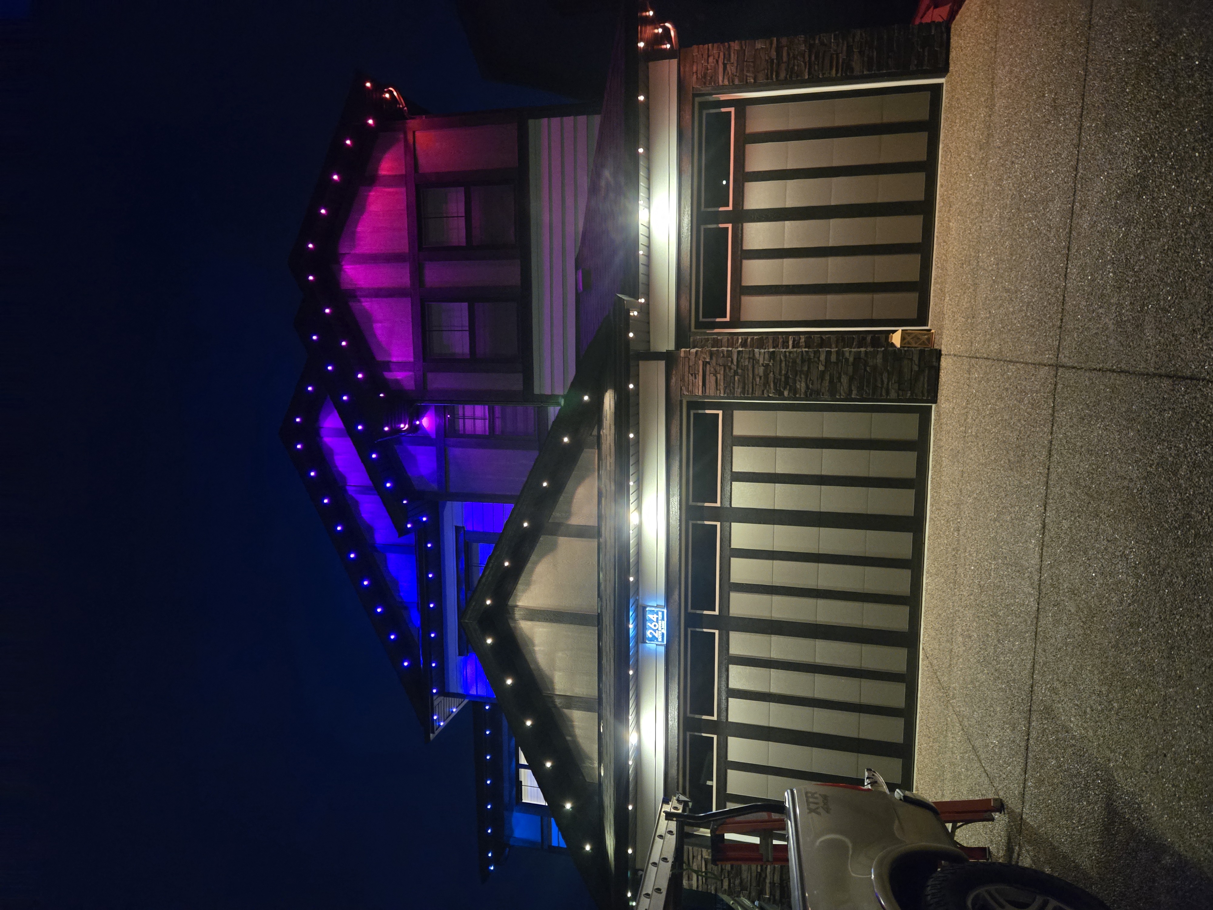 Two-storey Calgary home with a blue-to-magenta gable split in Govee permanent lights