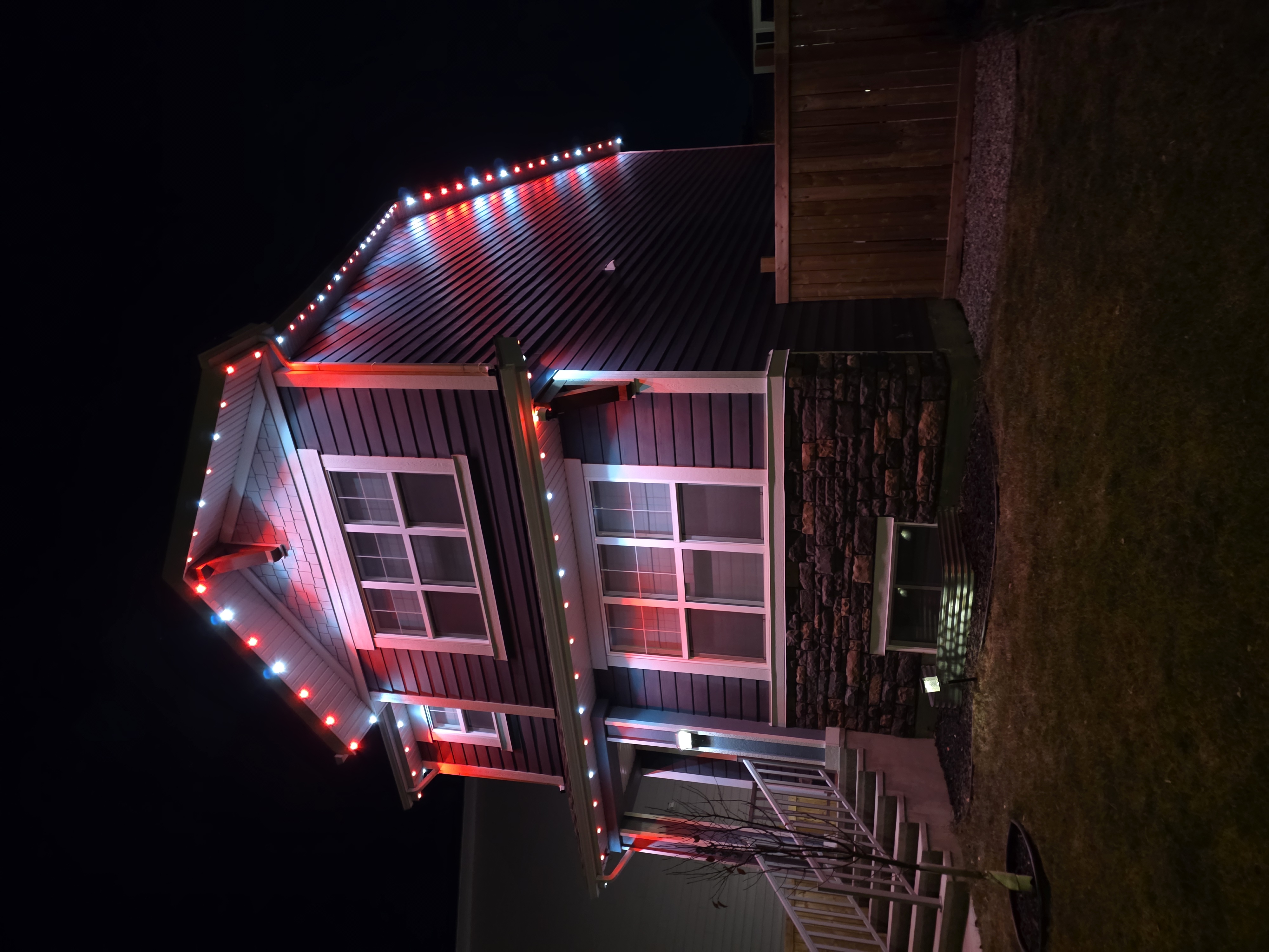Narrow two-storey home with an alternating red and white pattern on every roofline