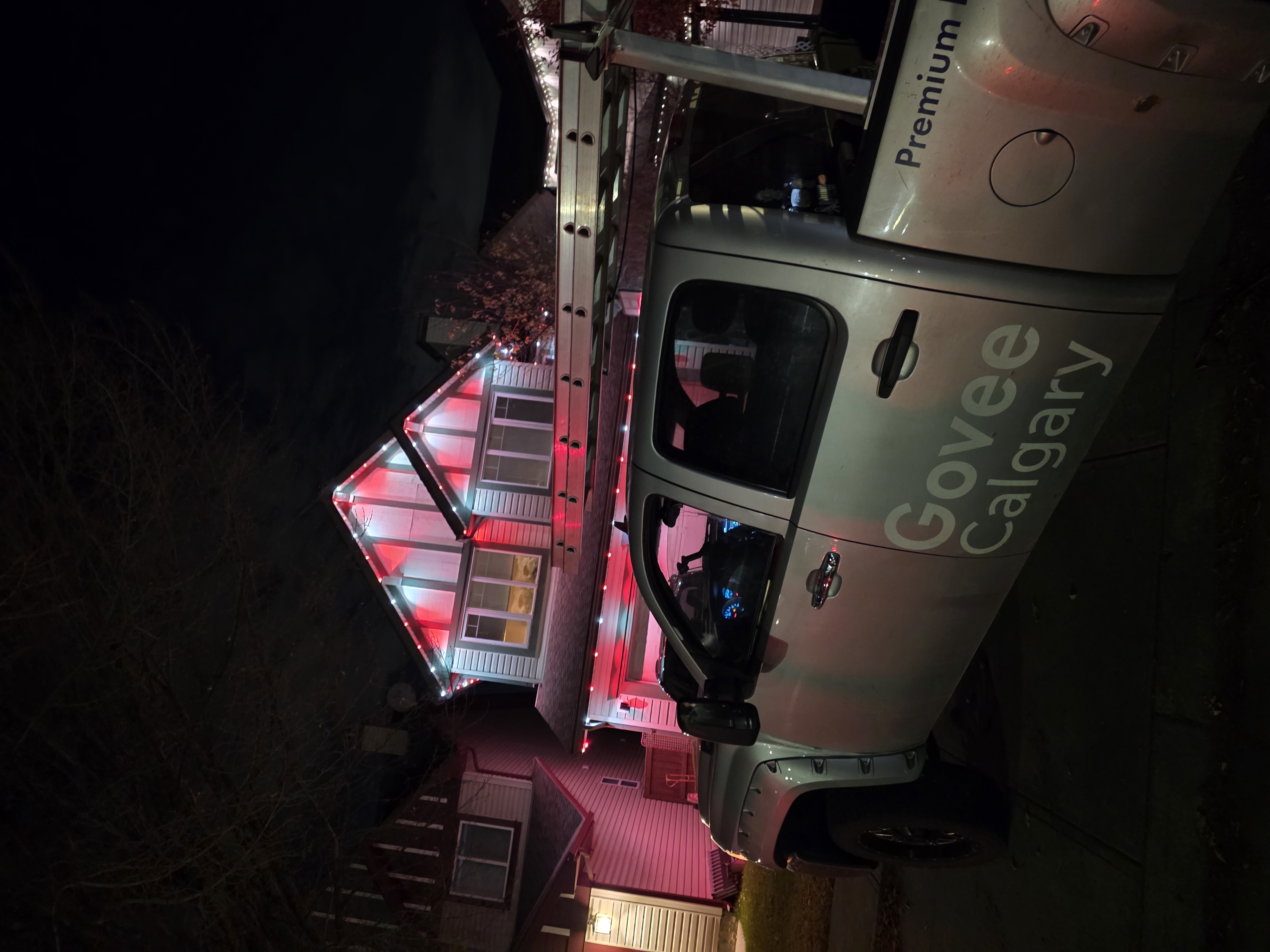 Home lit in alternating red and white with the Govee Calgary truck parked out front