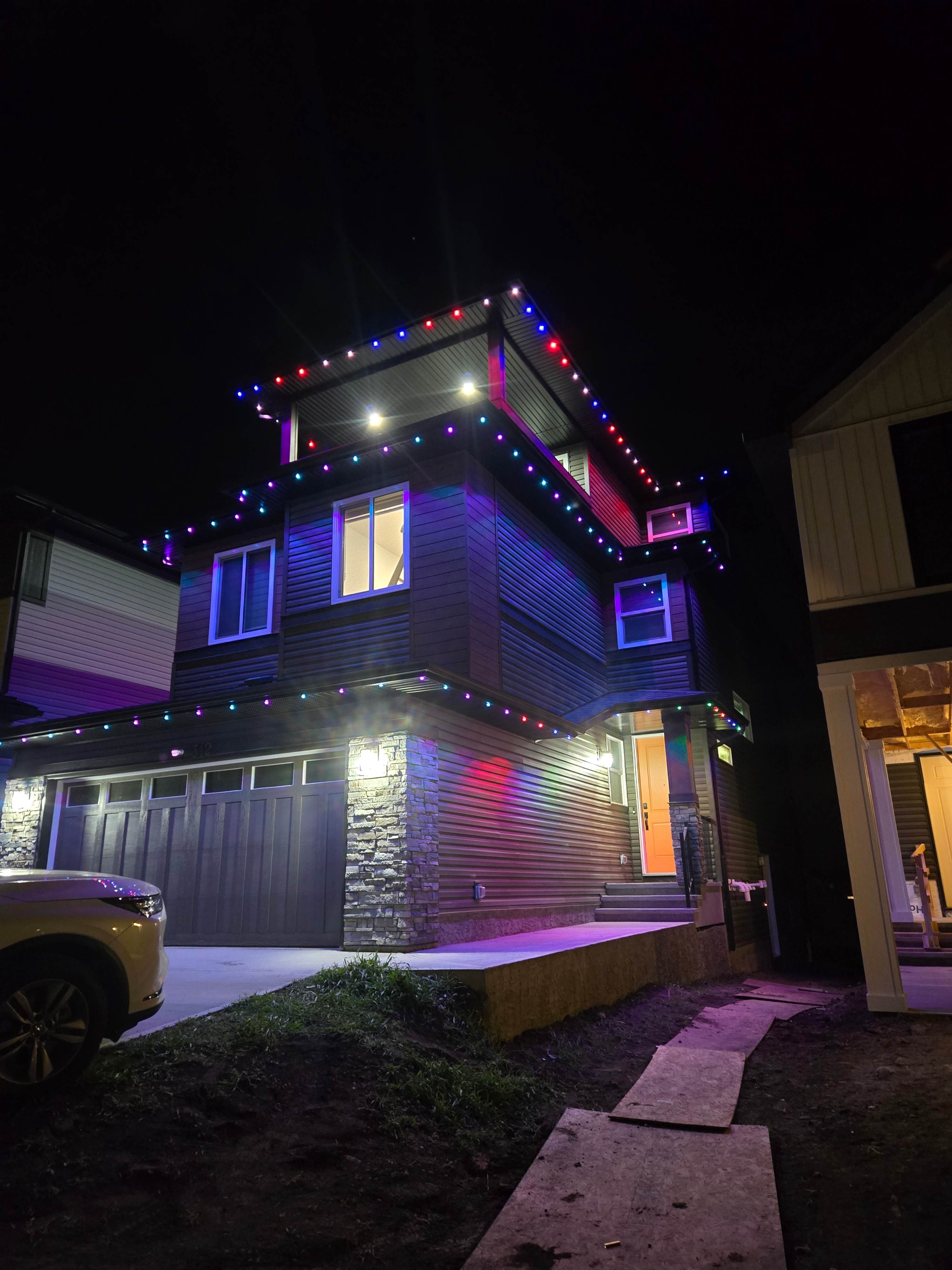 Home at night glowing with permanent LED track lighting turned on